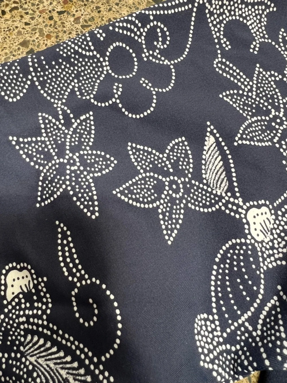 Roxy rashguard in blue with white floral design at sleeves